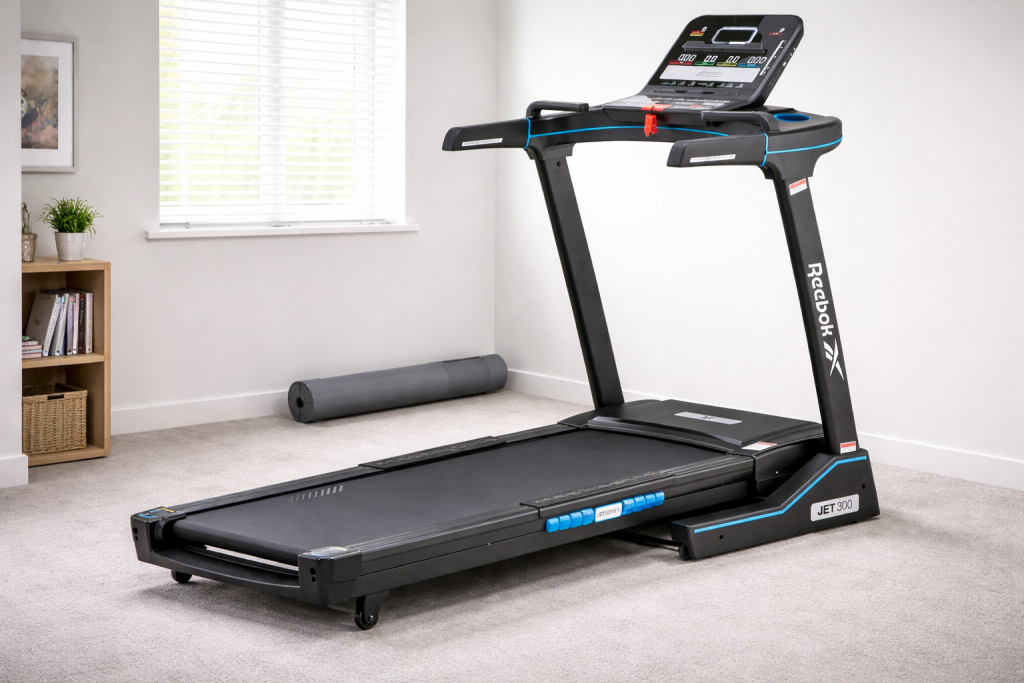 Reebok Jet 300 folding treadmill in a UK spare bedroom with grey carpet and natural light