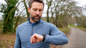 Runner checking a 5K finish time on a sports watch