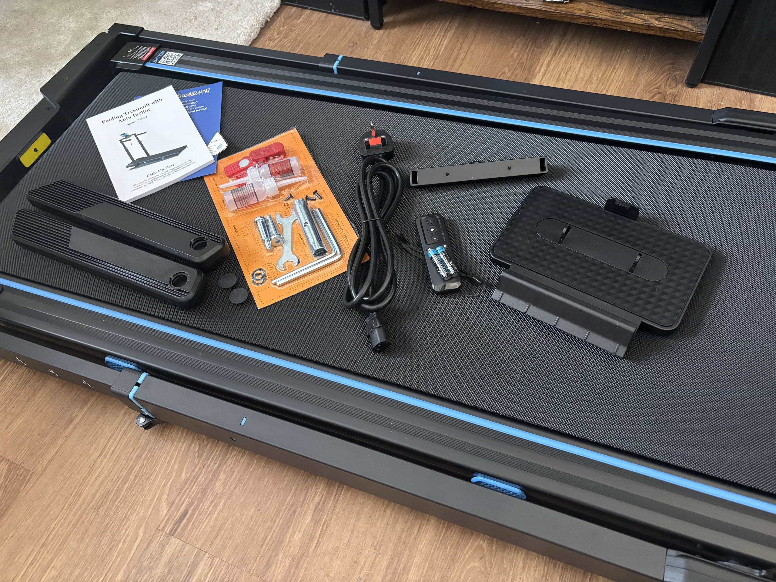 Full box contents laid out on the treadmill deck