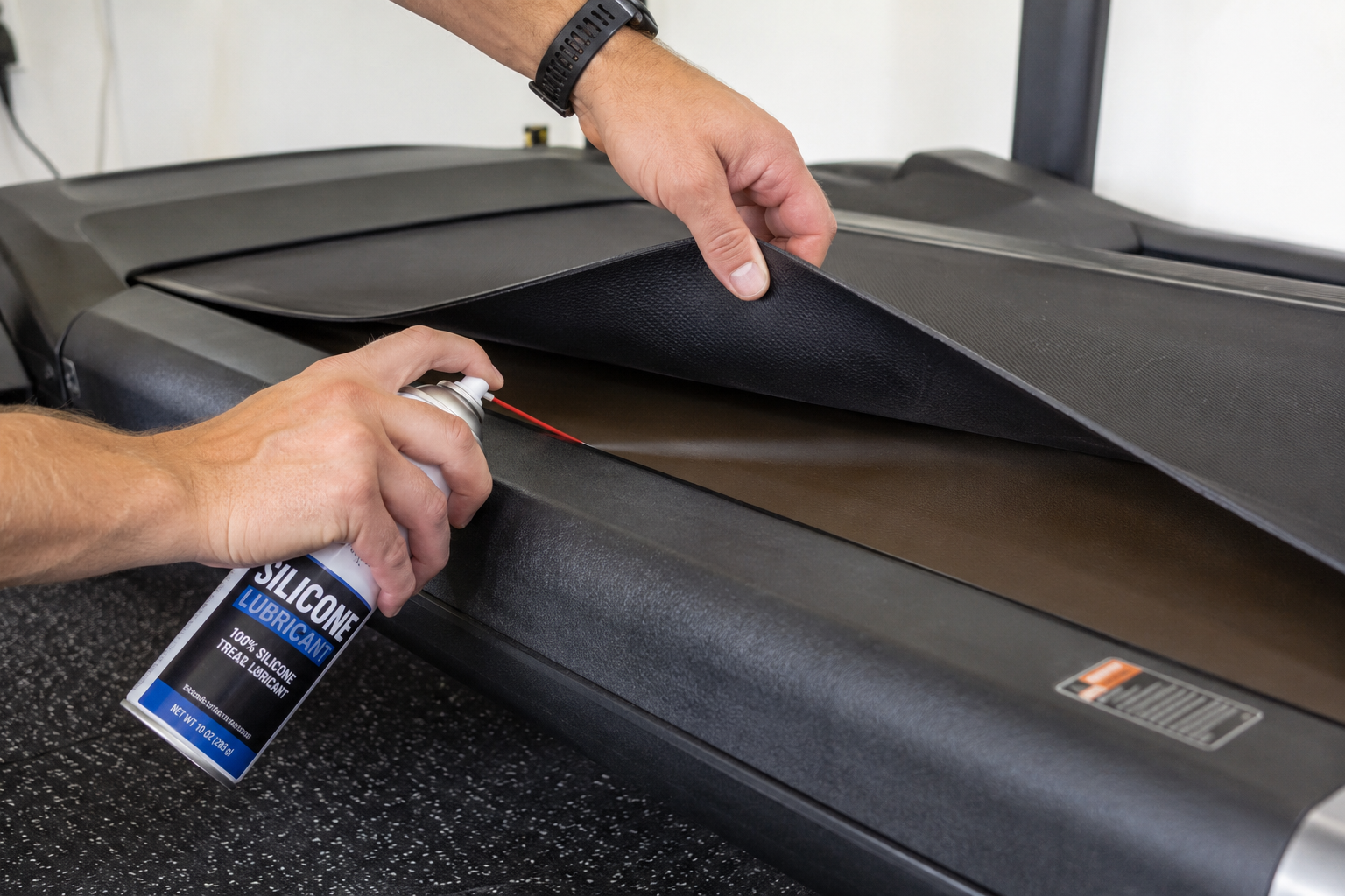 applying silicone lubricant under a treadmill belt