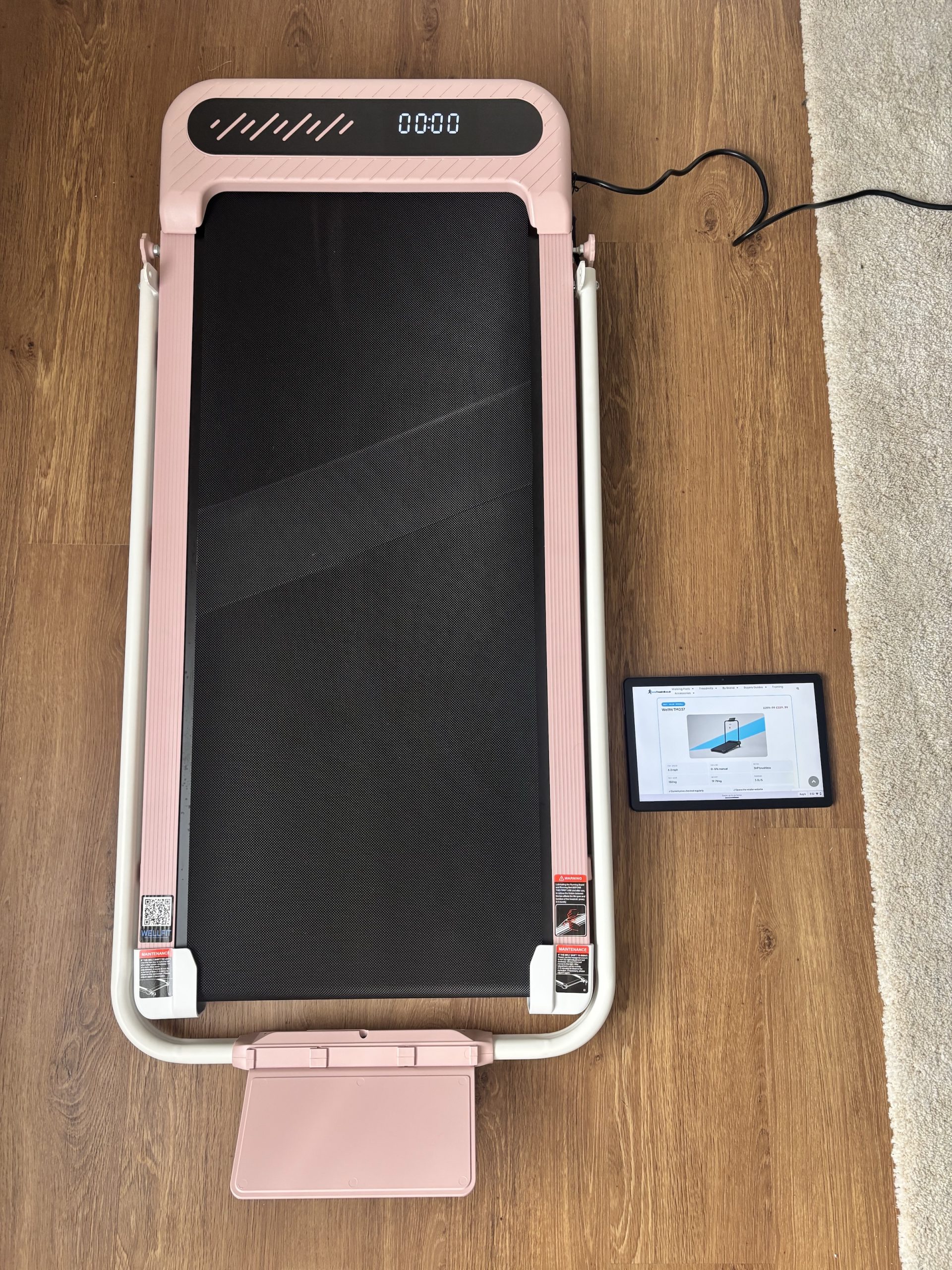 TM037 with handrail folded flat next to an iPad for scale