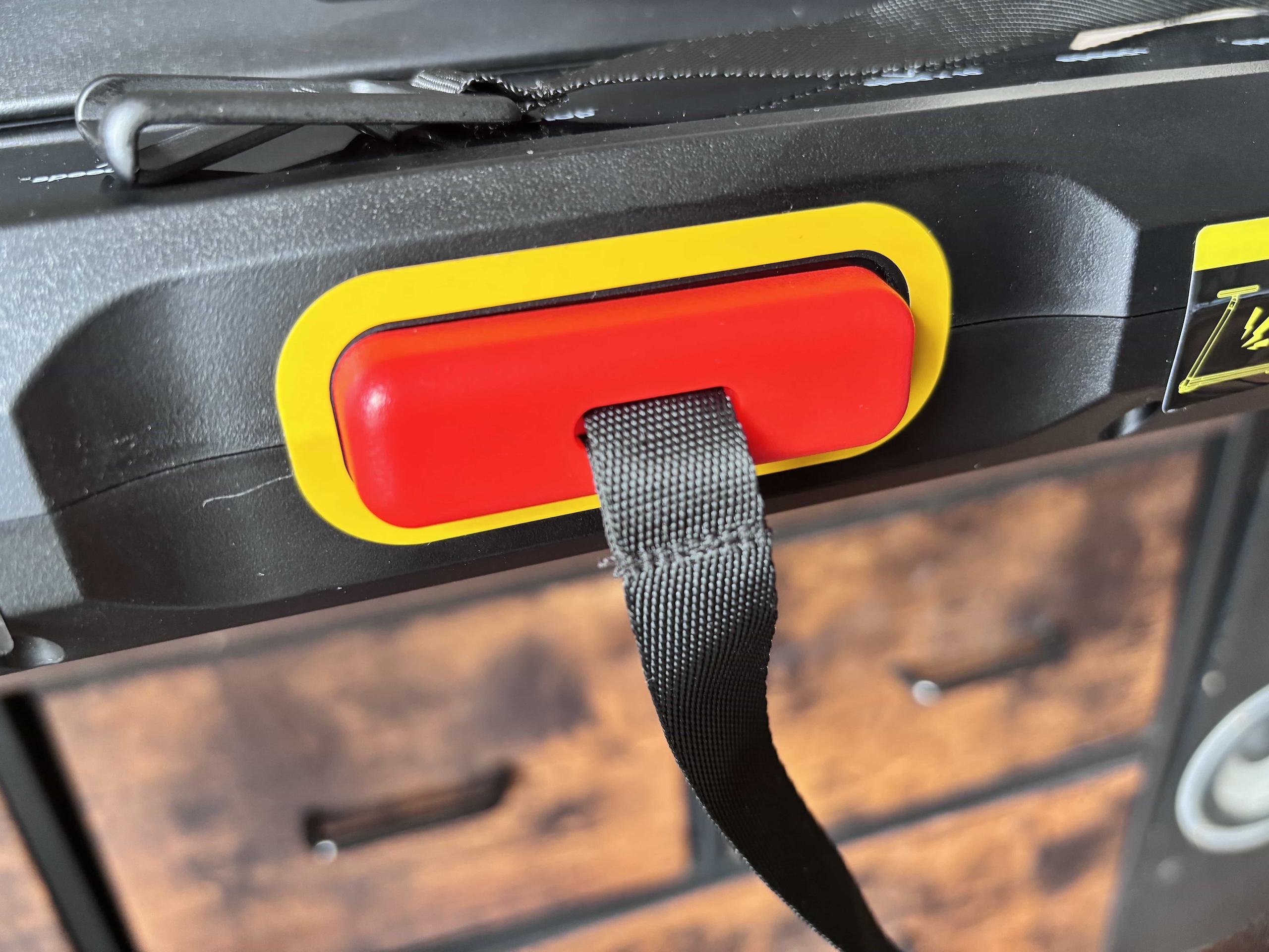Emergency stop cord clipped to the console