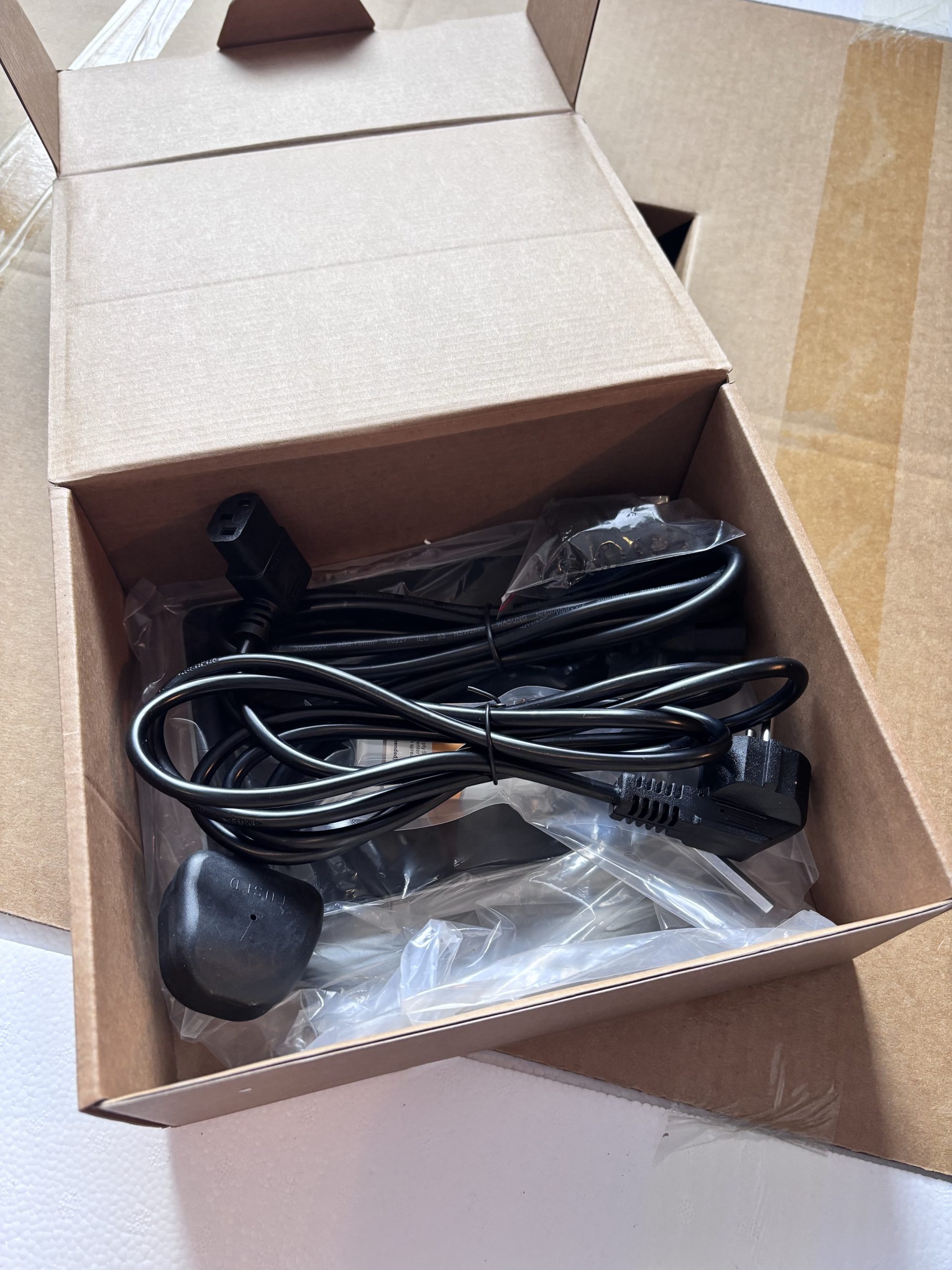 Contents of the tools box showing power cords and accessories