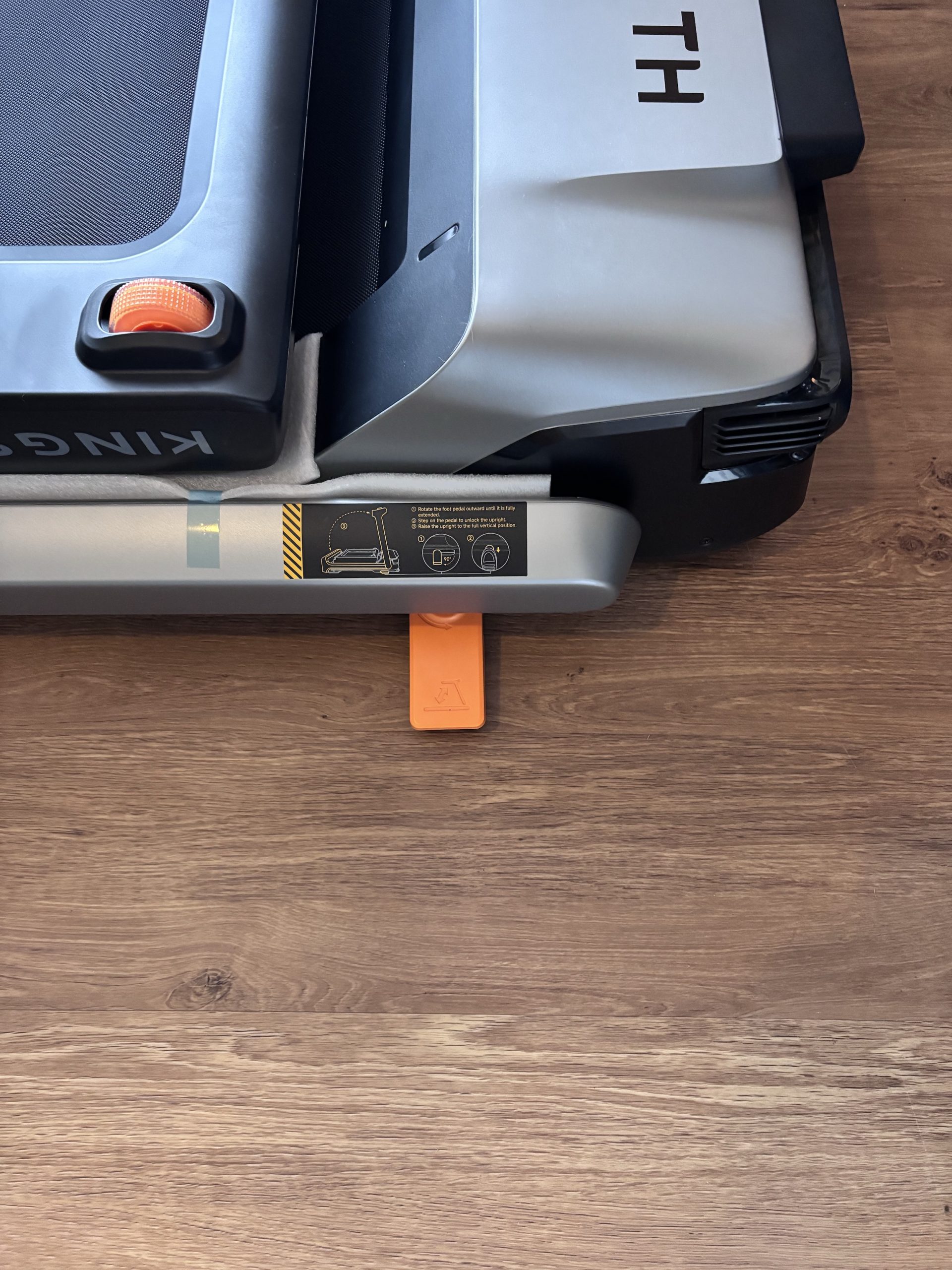The orange arm-release pedal, swung out ready to be used