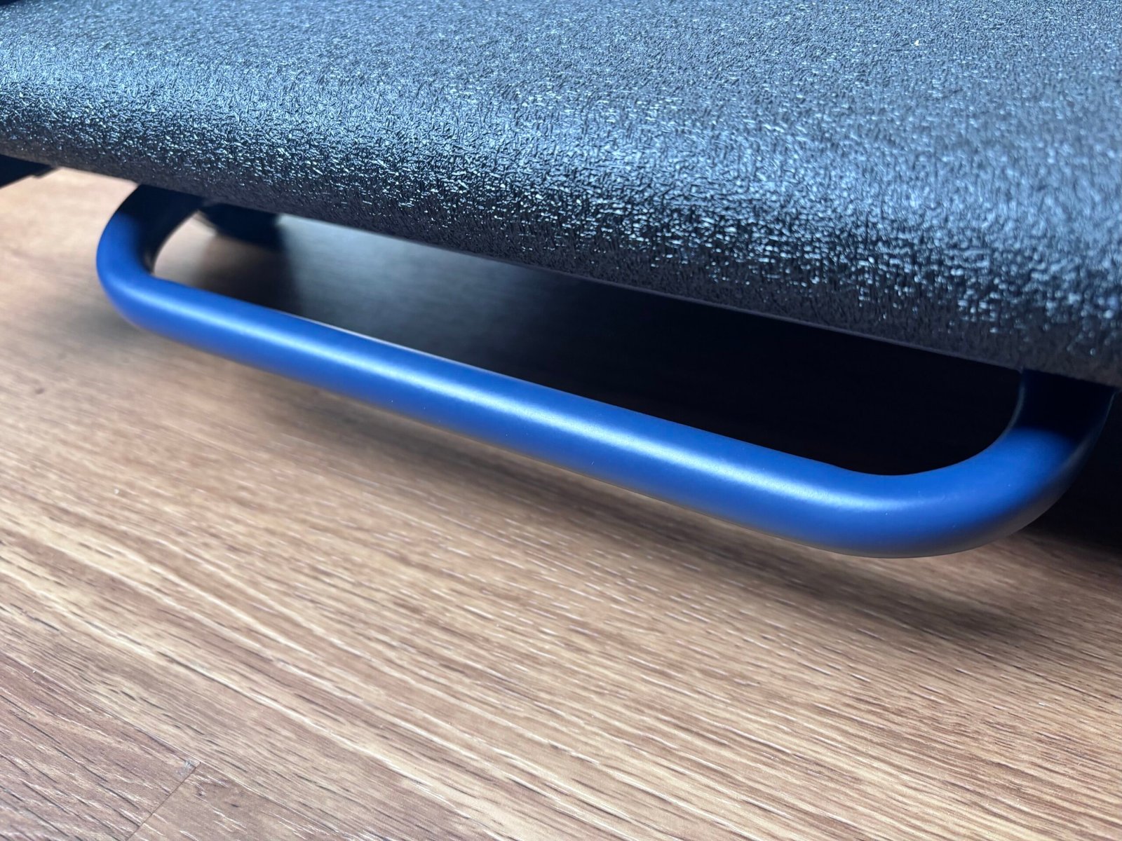 Large blue grab handle at the end of the UREVO CyberPad walking pad